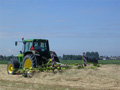 Deze maand waren wij volop bezig met het binnenhalen van het hooi. Om hooi van een goede kwaliteit te krijgen, waren wij genoodzaakt vaker het hooi te schudden dan gebruikelijk. Op de foto: de John Deere 6510 met Claas schudder. (Juni 2005)